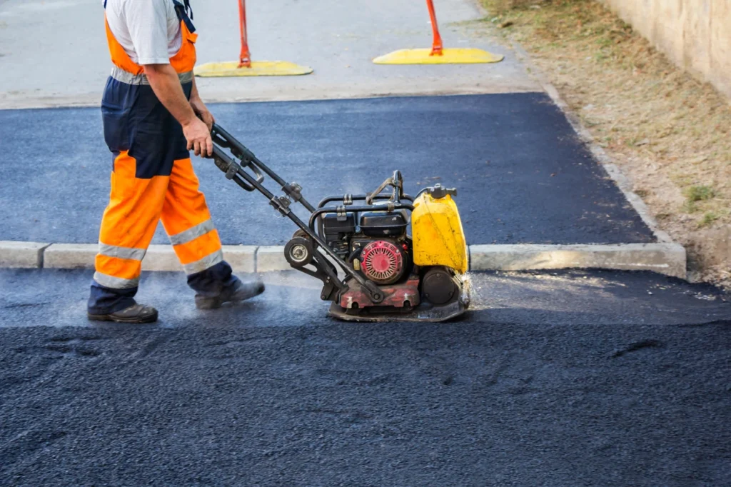 Skilled worker from Hawkes Bay Concrete Company compacting asphalt as part of Asphalt Contractors Hawkes Bay services.