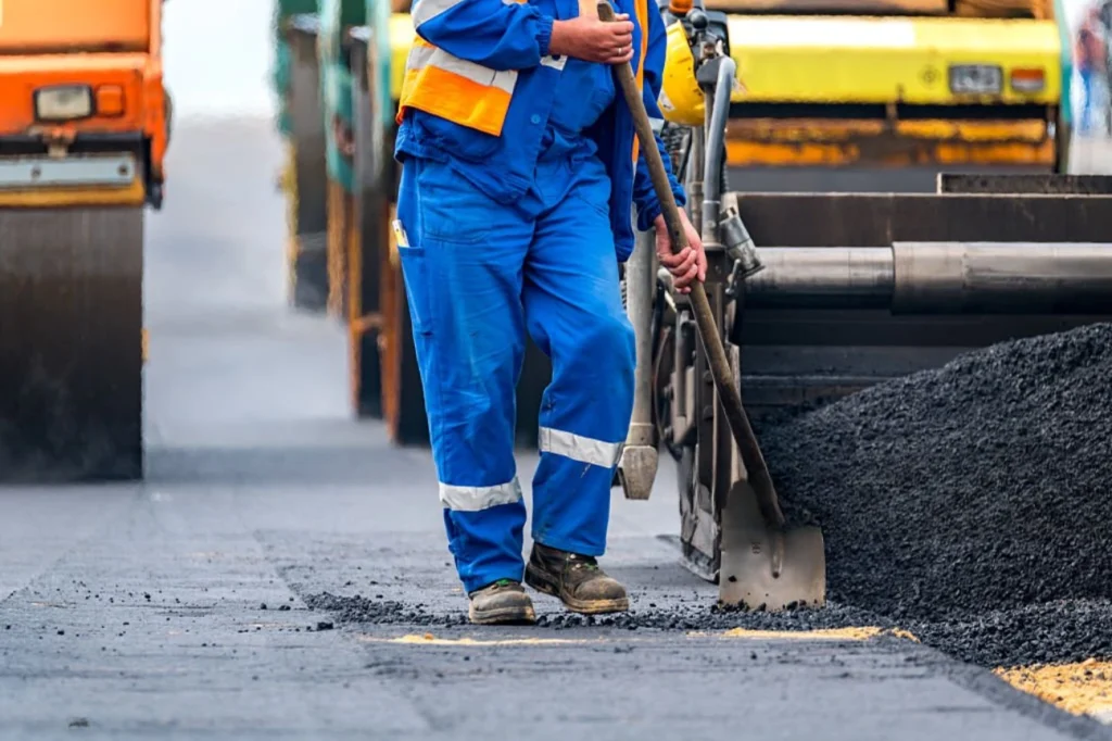 Hawkes Bay Concrete Company crew member smoothing asphalt as part of Asphalt Contractors Hawkes Bay service.
